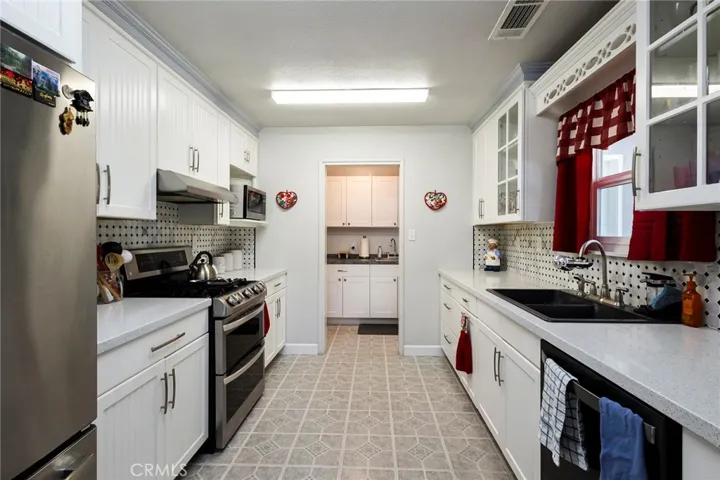 Completely Remodeled Kitchen with Stainless Steel Appliances, New Cabinets, Quartz Counters, Water-resistant Laminate and Glass Back Splash!