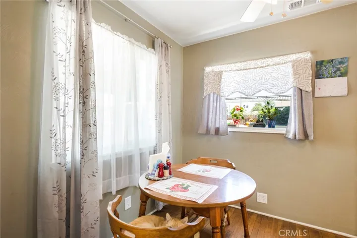 Dinning Area with lovely back yard view and original Hardwood Floors.