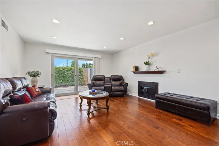 inviting wood floors and centerpiece fireplace