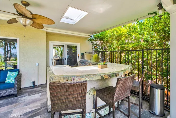 Built-in barbecue area complete with an extra burner, refrigerator, and sink