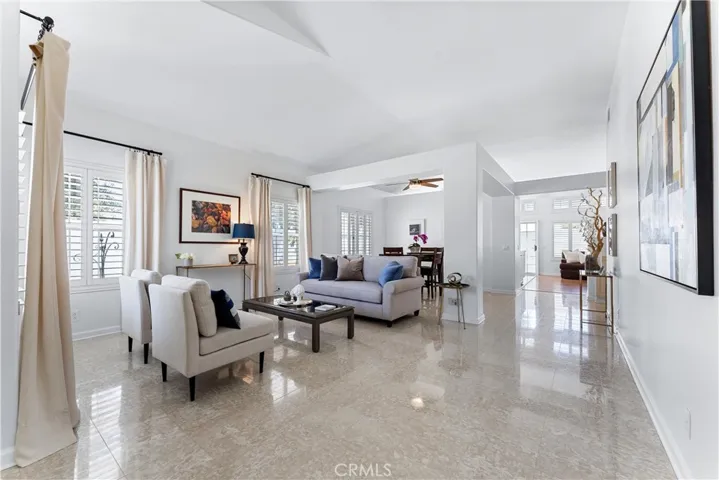 Showing an open floor plan with beautiful Marble flooring, high ceilings. Dual pane windows and shutters throughout the home.