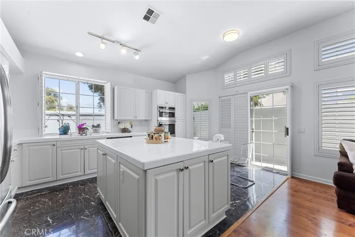 Kitchen with large kitchen island, lots of cabinets, all new stainless-steel appliances.