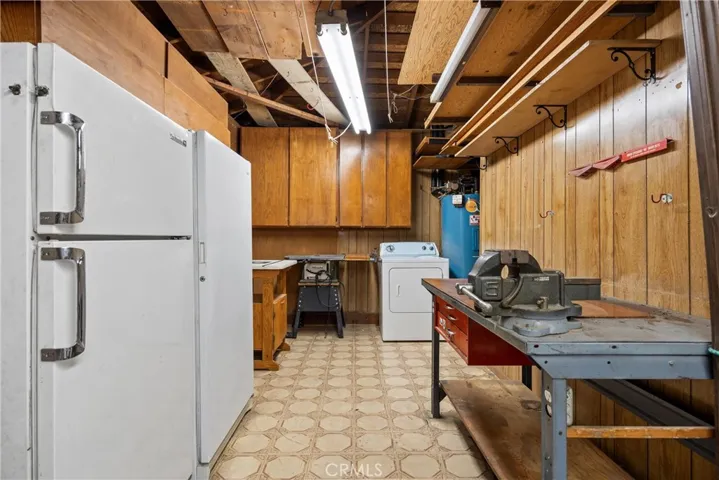 Separate Laundry room in 3rd car garage side, workshop area and large freezer included