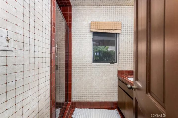 Guest Bathroom in West Wing with walk in tiled shower.