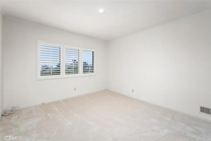 1st bedroom of West Wing. Custom shutters. New carpet. Mirrored closet doors. View room.
