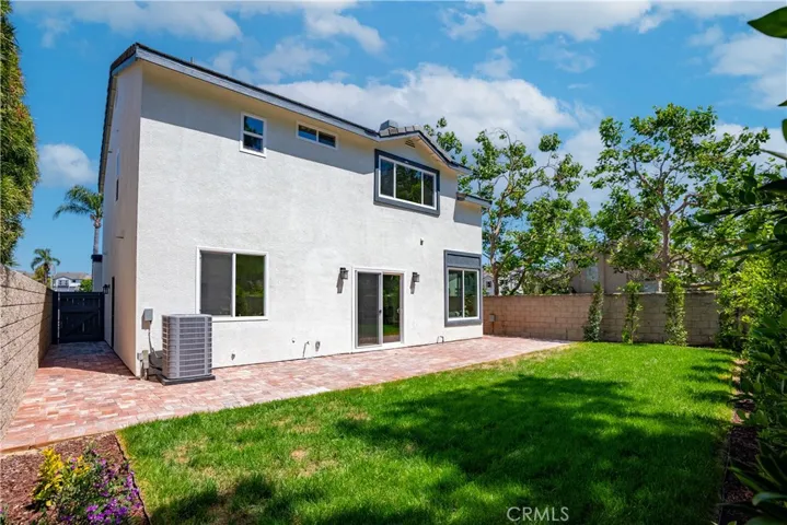 Backyard with grass and brick patio