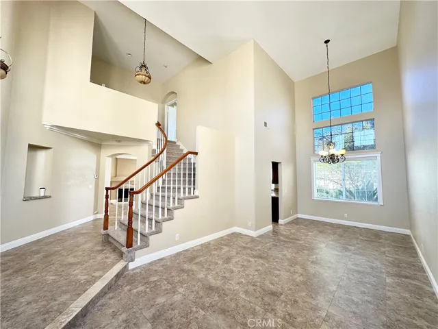 Formal living room and formal dining room with two story ceiling.