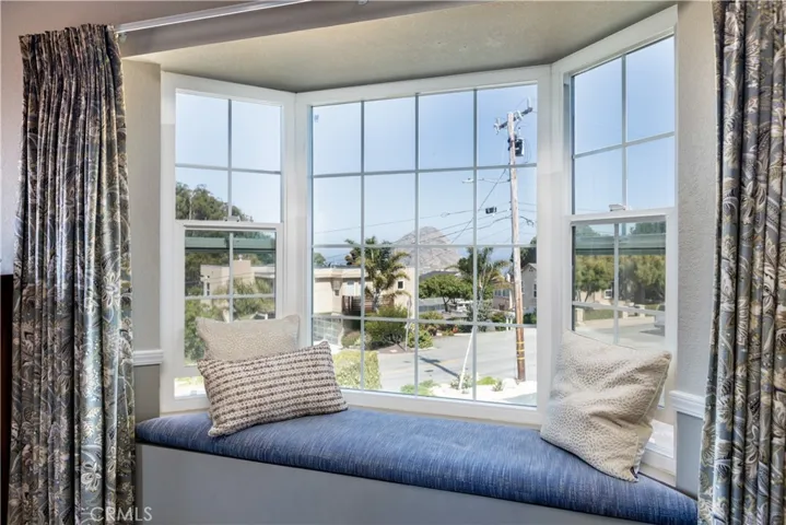  Spacious upper level primary suite with window seat and views of Morro Rock