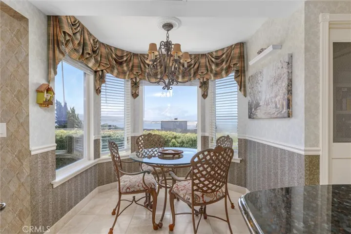 Kitchen alcove with stunning views of the water and backyard landscaping.