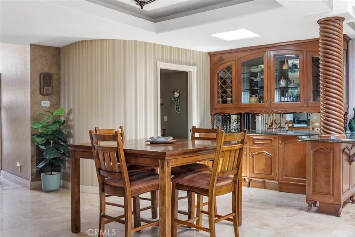 Lower level hosts a powder room with access to the side yard and a custom cabinetry wet bar in the great room area.