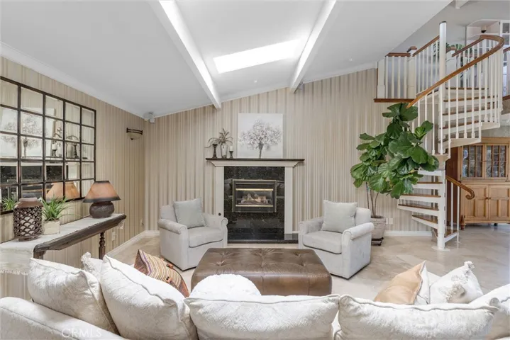 Living-family areas are spacious, and include a gas starter fireplace, higher ceilings, skylights, a spiral staircase taking you to the upper level loft!