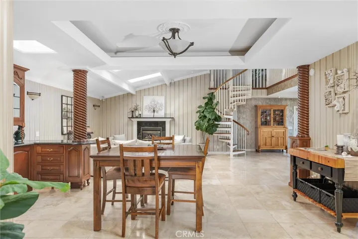 Travertine flooring, coffered ceiling, lot of natural light, and an open floorplan make for a perfect entertainer's paradise.