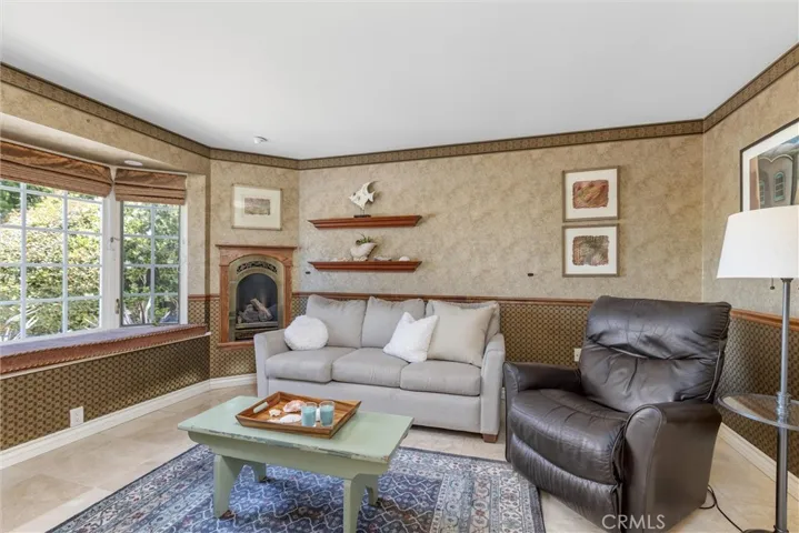 Front bedroom off the foyer has a gas fireplace, bay window with views of The rock and gas doors. This space is a perfect media room, office and or whatever suits your needs.