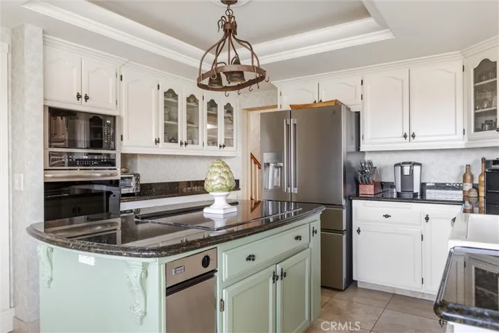 In this kitchen there is ample storage, granite countertops, a coffered ceiling, energy star appliances, and in addition, this home boasts 2 water heaters and two washers and dryers!