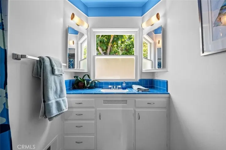 Hall bath with original blue tile in pristine condition.