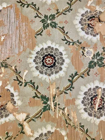 Original distressed wall paper in entry.