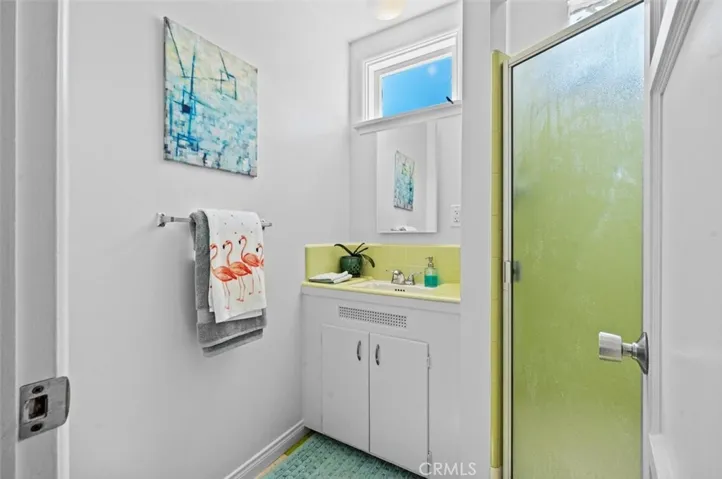 3/4 bath with shower and original lime green tile.