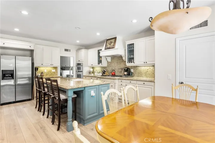 contrasting cabinetry, with a designer pastel island