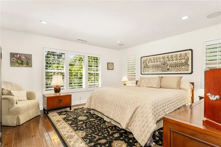 a large primary suite, with views of the trees