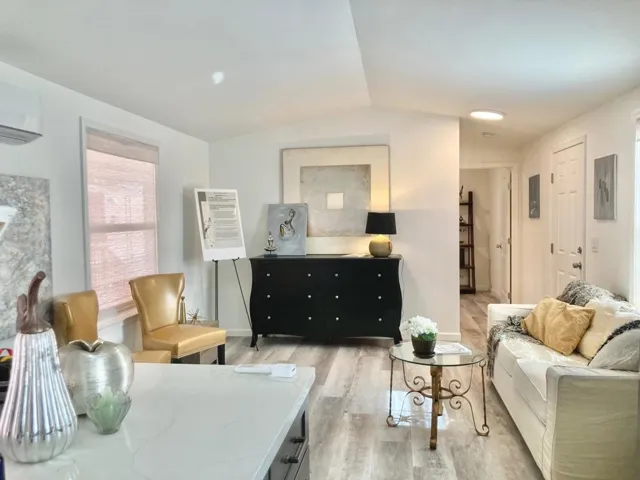 Peaked 9' ceilings. View from kitchen looking down hallway to 2nd bedroom/adjacent bathroom