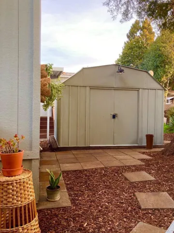 Storage shed has a solar light, and paver patio - making it more pleasurable/cleaner access.