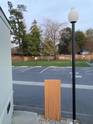Across from the home is a visitor parking area and the greenbelt area