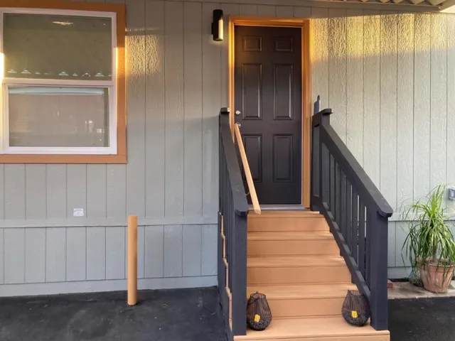 Back door from the driveway entry is LED dusk to dawn lighting. Bollard to guide your parking depth.