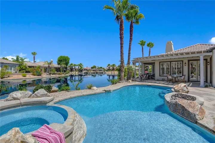 Hot tub, pool, lake, and water fall feature.