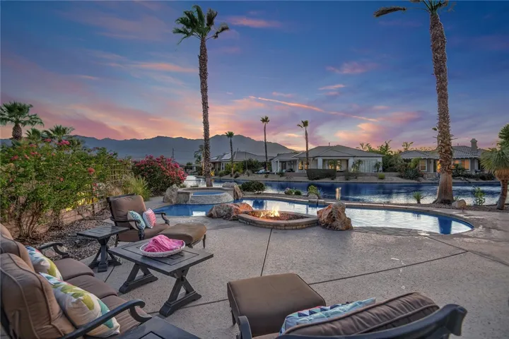 Backyard patio with fire pit at sunset
