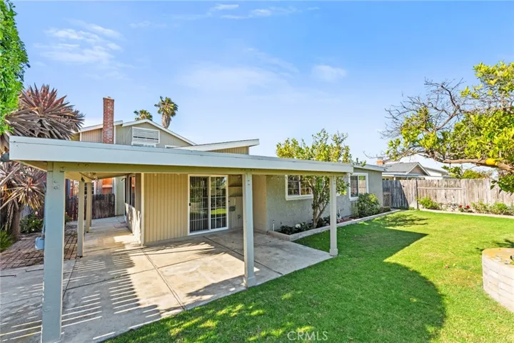 Tranquil Oasis Paradise Backyard with Covered Patio, Lush Lawn, Gorgeous Gardens, Block Wall Fencing