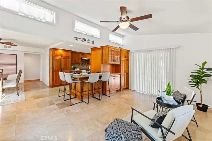 Family Room with High Transom Windows, Custom Built-In Cabinetry, and Sliders that Open to a Tranquil Oasis Paradise Back Yard with Covered Patio.