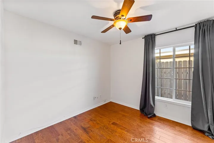 Bedroom #4 Downstairs has Hardwood Floors, Mirrored Closet Doors and Ceiling Fan