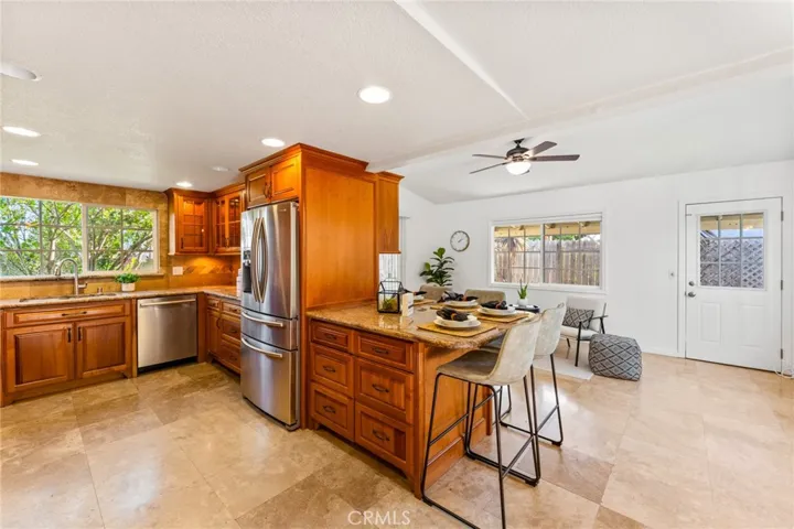 Wrap-Around Breakfast Bar that Extends into the Gorgeous Family Room with Vaulted Ceiling, High Transom Win Windows for Lots of Natural Light