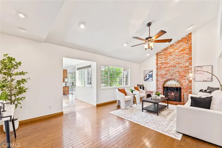 Luxurious Living Room with Hardwood Flooring, Floor-to Ceiling-Brick Fireplace, Recessed Lighting