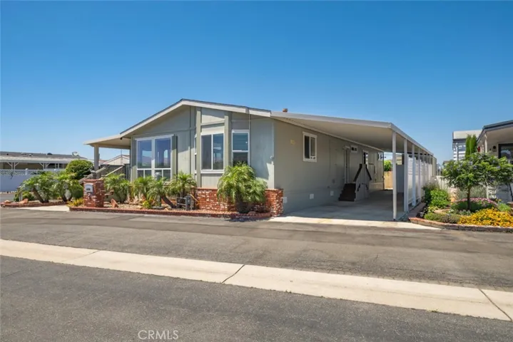 Spacious covered carport offers concrete driveway with lots of shade throughout the entire day.