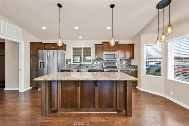 The kitchen also features stainless appliances including refrigerator, freestanding gas range with double oven, Stainless dishwasher and microwave round out the appliances.