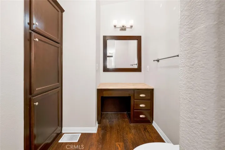 Master bathroom makeup vanity and linen storage cabinet.
