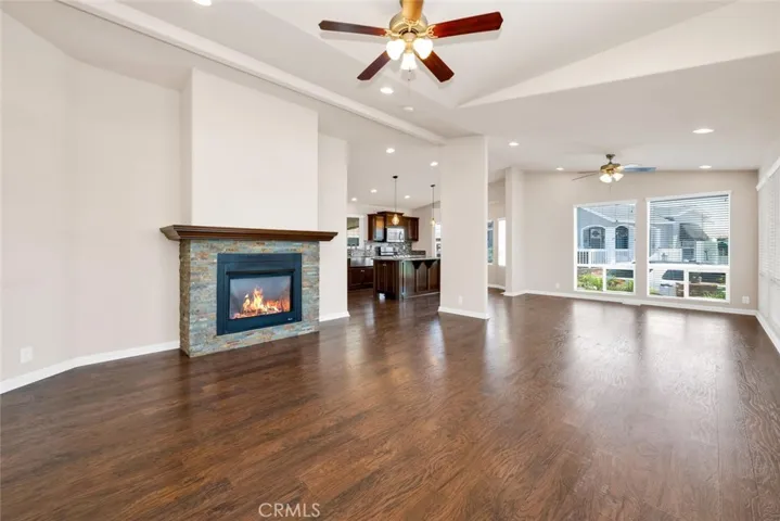 Living room features include high ceilings, gas fireplace with automatic starter, simulated wood laminate flooring and an amazing amount of windows and natural light.