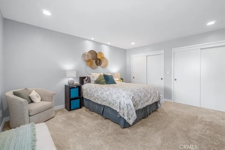 Spacious primary retreat with lush carpet and lots of closet space.