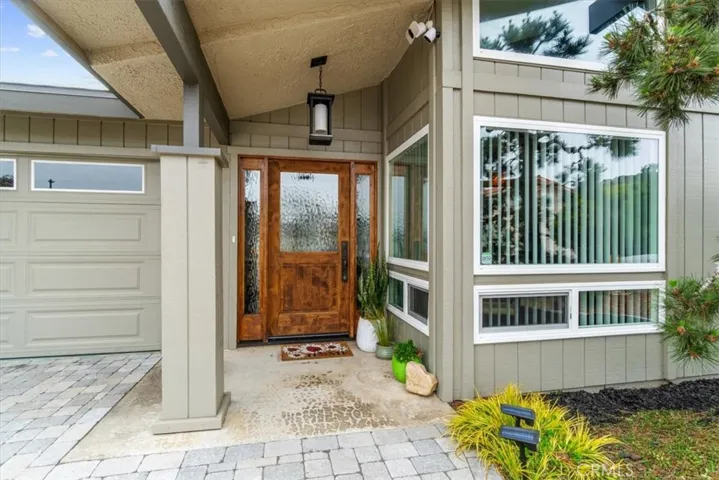 Custom wood front door and newer dual pane windows.