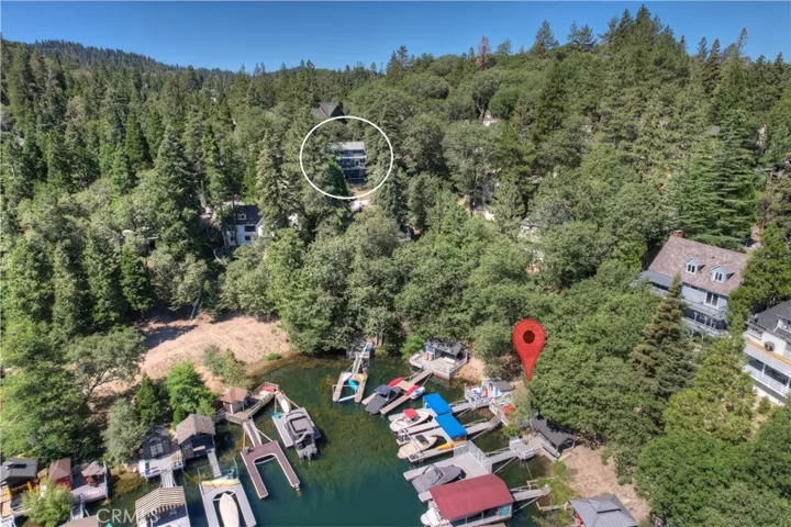 The home is on the lake side of the street. Steps to the left of the driveway take you down to your own single slip dock with a dock house.