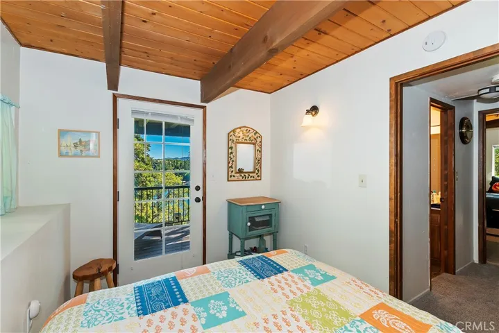 Lower level bedroom with lake views and with a door to decking.