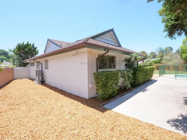 Continue the tour around the house from the concrete pation at the rear of the 4th bedroom to the huge currently unutilized huge side yard to make into whatever you want...gardening, pets, or more playspace for kids.