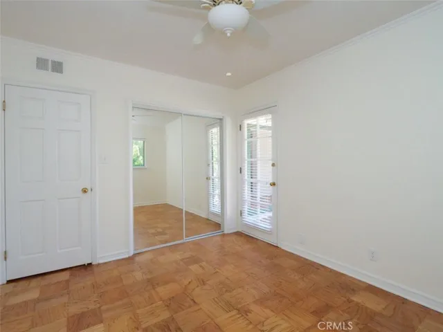 Bedroom 4/office with ceiling fan, refinished floors and fresh paint and easy egress to the patio.