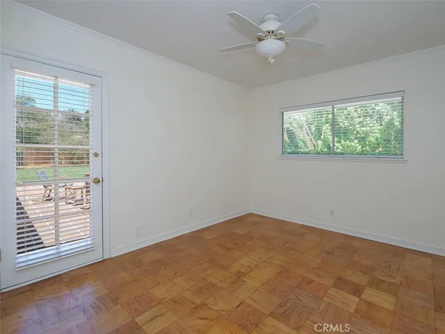 Freshly painted fourth bedroom/office with newly refinished floors, ceiling fan and with its own access to the patio and yard
