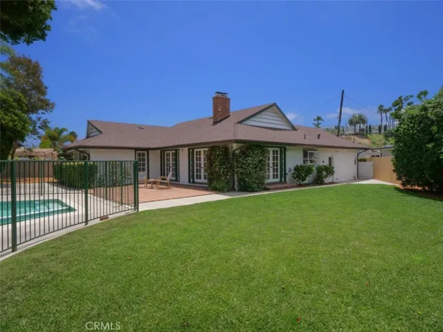 View of large yard and patio with numerous doors allowing an easy flow from the rear of the house allowing the ultimate indoor/outdoor lifestyle.