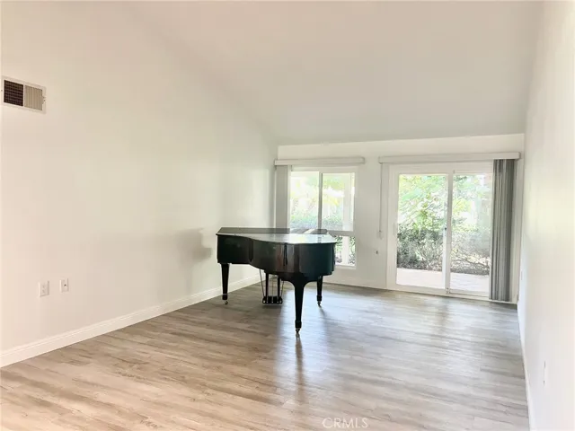Large Living Room with Vaulted Ceilings and Sliding Doors to Rear Patio & Adjoining Park