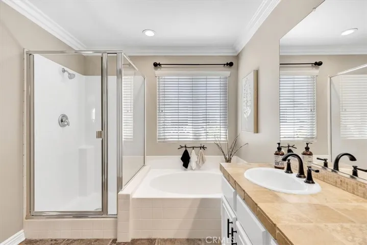 Separate soaking tub and step-in shower create a spa-like vibe in the primary bathroom.
