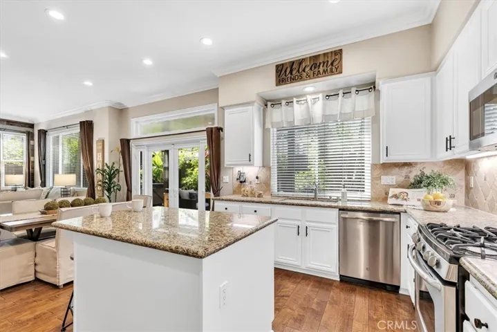 Adjacent to the dining area, the kitchen features a gas range and oven, stainless steel appliance suite and new microwave oven. Throw open the French doors for easy meals on your back patio.
