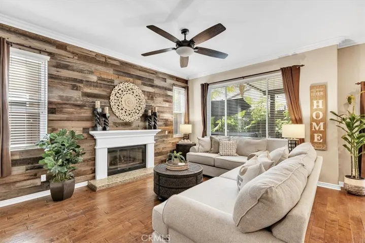 The cozy family room is anchored by a gas fireplace and showcased by a custom wood barn accent wall.